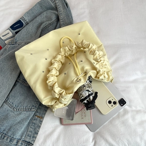 Cream pleated tote bag with diamond embellishment and drawstring closure for women