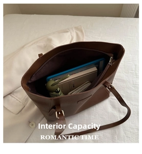 Macro shot of large brown tote bag interior showing capacity for iPad and essentials