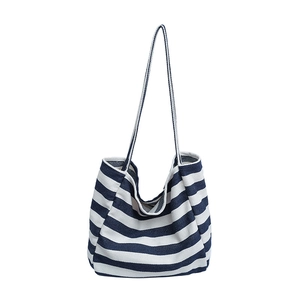 Minimalist blue and white striped canvas tote bag with long shoulder straps for casual use