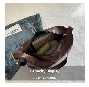 Macro shot showing large capacity of the dark brown leather tote bag with daily items