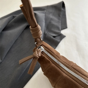Brown matte suede crossbody dumpling bag with knot detail and silver zipper