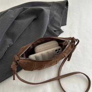 Brown frosted suede dumpling shoulder bag with pleated design and decorative knots