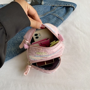 Pink woven crossbody phone bag with two zipper pockets and colorful wave patterns