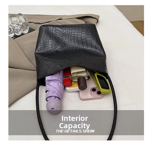 Interior view showing large capacity of the black crocodile pattern tote bag with essentials