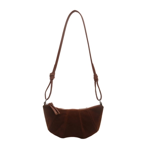 Retro dark brown suede croissant bag with knotted shoulder strap on white background