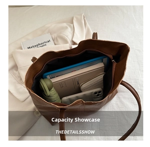 Brown tote bag interior showing capacity with tablet, umbrella, and wallet inside