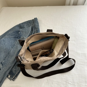 Minimalist beige canvas tote bag with brown straps showing large capacity interior space
