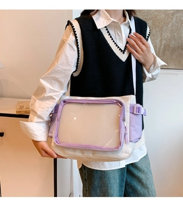 Detail of white nylon tote bag showing clear PVC front pocket and purple accents