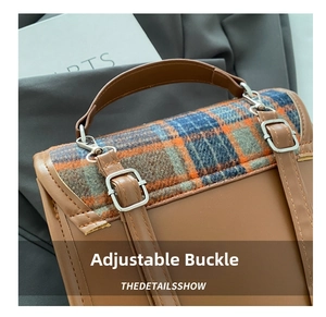 Close-up of adjustable metal buckle on plaid wool shoulder bag with PU leather trim