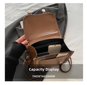 Detail of interior storage showing brown leather flap backpack with plaid pattern