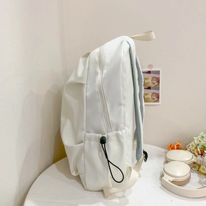 Minimalist white nylon backpack with breathable mesh straps for travel and school