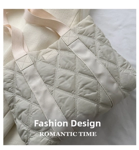 Macro detail of quilted large diamond pattern on soft nylon tote bag with reinforced handles