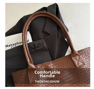 Close-up of brown woven leather texture on a chic tote bag styled with professional attire