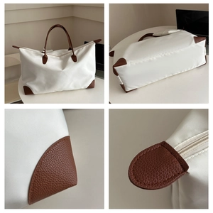 Close-up of waterproof Oxford fabric texture with brown lychee leather corner and stitching