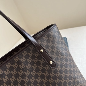 Chic brown tote bag with M-pattern print and luxury gold rivet details on shoulder strap