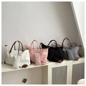 Waterproof nylon tote bag set with leather handles and matching pouches in four colors