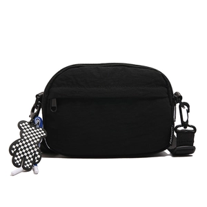 Waterproof black nylon crossbody bag with fashion tag and checkered bear charm accessory