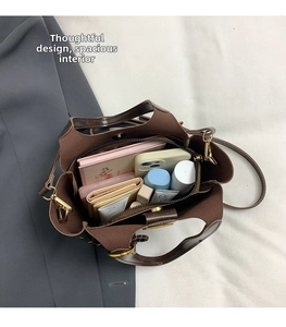 Detailed top view of brown leather tote showing spacious interior for tablet and phone