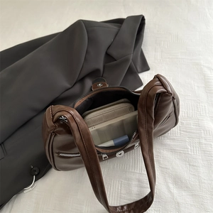 Deep brown matte leather dumpling bag showing large capacity with daily essentials