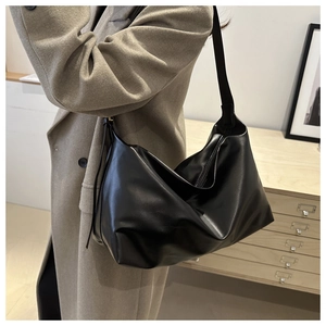Side view of a black PU leather hobo bag showing its soft texture and large capacity