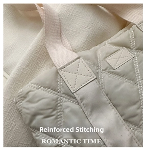 Close-up of reinforced stitching on a quilted Oxford cloth tote bag with Romantic Time logo