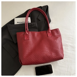 Detailed top view of red woven tote bag showing texture with commute essentials