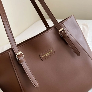 Large dark brown faux leather tote bag with adjustable straps and gold metal hardware