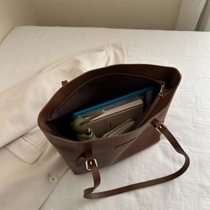 Large capacity brown tote bag with adjustable straps showing spacious interior for essentials