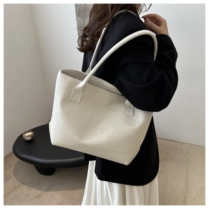 Detailed close-up of off-white woven texture on a premium large capacity tote bag