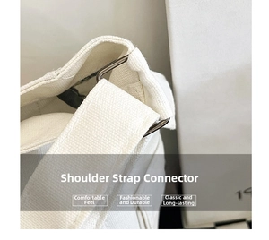 Detailed macro view of durable canvas shoulder strap with silver metal connecting ring