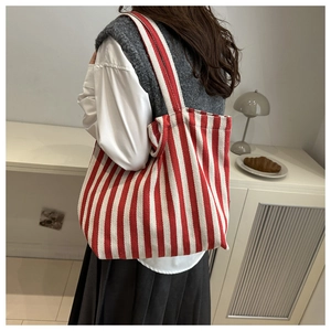Close-up of red and white striped canvas tote bag showing thick high-density fabric texture