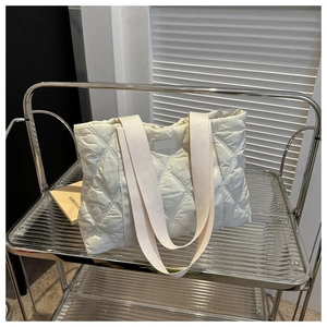 Quilted oxford fabric tote bag in cream white showing the diamond stitch and canvas handle