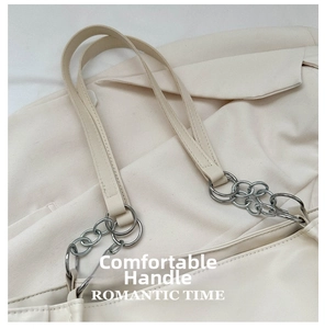 Close-up of retro ivory tote bag showing silver chain link and soft PU leather texture