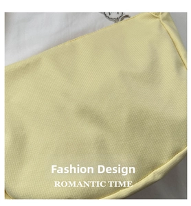 Detailed close-up of light yellow knitted tote bag showing fine woven grid texture