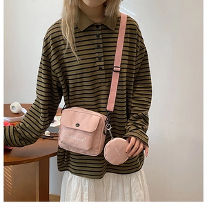 Pink nylon crossbody bag detail with Dachshund embroidery and adjustable strap