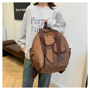 Brown nylon travel backpack with a spherical design, dual handles and large capacity