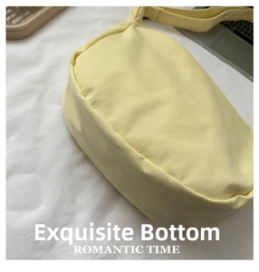 Detailed side view of yellow nylon dumpling bag showing wide bottom and twill texture