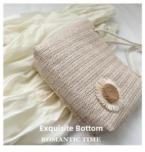 Close-up of beige woven tote bag with a 3D sunflower floral decoration and rope strap