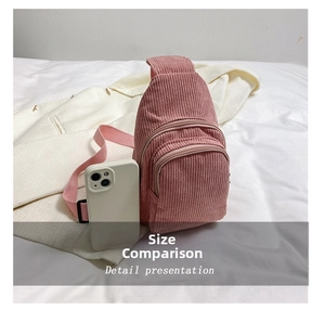 Pink corduroy crossbody bag size comparison with a white smartphone next to it
