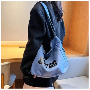 Detail of Morandi blue canvas tote bag featuring black Happy Times slogan and adjustable strap