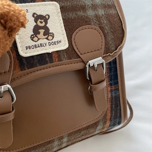 Plaid messenger bag with bear patch and faux leather trim in vintage autumn style