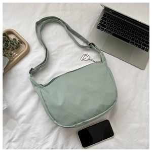 Mint green corduroy crescent crossbody bag with white sheep charm and adjustable strap