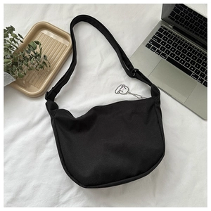 Black canvas half-moon crossbody bag with cute sheep charm and adjustable strap