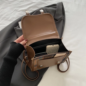 Brown leather crossbody bag with plaid texture showing spacious multi-layer interior