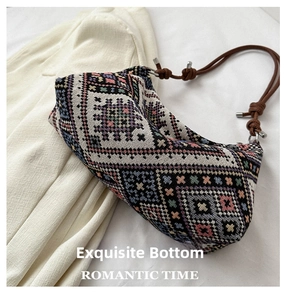 Detail shot of multicolor geometric woven fabric and brown knotted rope handle with metal accents