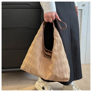 Quilted beige hobo bag detail showing the soft texture and fashion letter label