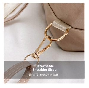 Detail showing the golden metal detachable hook and neat stitching of the shoulder strap