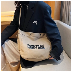 Detail of canvas crossbody bag with Good Times print and functional side pocket