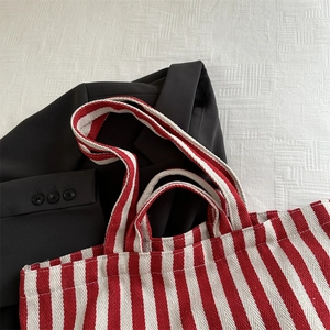 Large striped canvas tote bag with red and white patterns for daily commute use