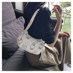 Chic white underarm bag featuring cute cartoon duck prints and wide graphic strap